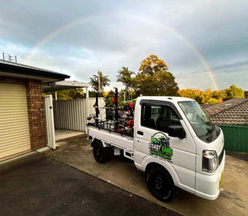 The Coast Care truck parked at a customer's home with a rainbow behind
